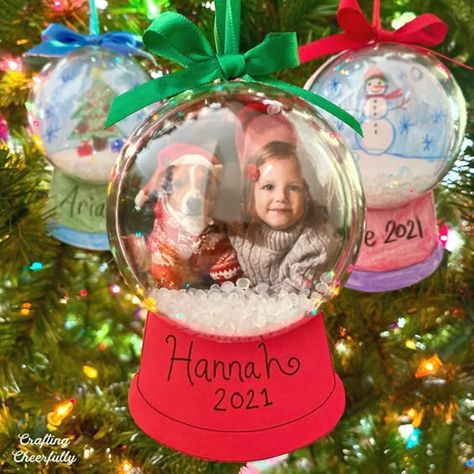 DIY Snow Globe Ornament Kids Can Help Make Christmas craft ideas #christmascraftideas Christmas craft idea #christmascraftidea #christmas #craft #idea merry christmas #merrychristmas 4.305 Kids Snow Globe Ornament, Kids Craft Snow Globe, Kids Snowglobe Ornament, Snow Globe Laminated Ornament, Snowglobe Picture Ornaments Diy, Picture Snowglobe Ornament Craft, Picture Snow Globe Diy, Snow Globe With Picture Inside, Diy Snow Globe Ornaments For Kids