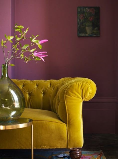 Deep mustard hues and dark shades of red like berry are on trend this season when it comes to decorating. Wall Color Schemes, Yellow Couch, Yellow Sofa, Velvet Couch, Purple Walls, Beautiful Sofas, A Living Room, Colour Schemes, 인테리어 디자인