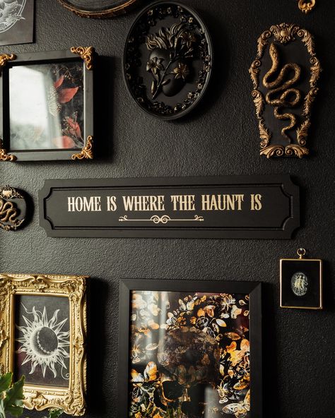 Give in to your heart's desire for spooky season with House of Persephone's "Home is Where the Haunt is" wall plaque. Perfect for those who embrace ghostly goodness all year-round, this sign is ideal for hanging in your living room, bedroom, entryway, or any spot that could use a bit of eerie elegance. The matte, black background paired with subtly reflective gold text creates a beautiful contrast that catches the eye without overpowering your decor. Whether you're looking to enhance your own da Spooky Maximalist Decor, Black Wall Gold Frames, Goth Fall Decor, Weird Core Decor, Earthy Gothic Decor, Witch Aesthetic Living Room, Spooky Decor Home, Dark Academia Hallway, Spooky Academia