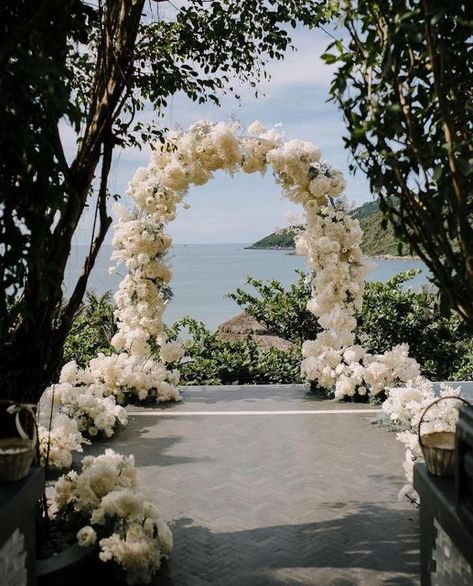 Italy Wedding Bride on Instagram: "Taking inspiration from this all white wedding arch overlooking the sea 😍💕💎 Those crisps flowers!! 🌸🤍 Tag @italyweddingbride and use #italyweddingbride to get featured! ⁠😘⁠ Planner and Design @theplannersvn Venue @intercontinental @intercontinentaldanang Rental @allgoodthings.rentals #wedding #weddingdesign #weddingdecor #weddingdecoration #italy #weddingceremony #weddingdress #weddingphotography #vietnamwedding #asianwedding #weddingstyle #weddinginspira Sea View Wedding Ceremony, Wedding Arch Balloons And Flowers, White Flower Arch Wedding Outdoor, Classy Wedding Arch, White Flower Arch Wedding, Wedding Arch White Flowers, Classy Wedding Ceremony, Wedding Arch White, White Floral Arch