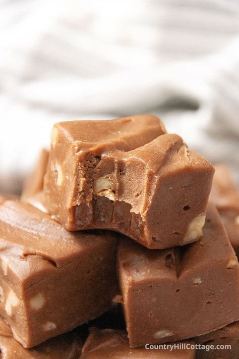 Simple Velveeta fudge is so soft, creamy, and delicious! This cheese fudge recipe is easy to make and has pieces of pecans throughout for a nutty crunch. It has everything you love about good fudge! It's soft and creamy and has nice little bites of crunchy pecans or walnuts throughout. And the flavor is deliciously sweet and chocolatey. Homemade chocolate Velveeta cheese fudge the perfect treat to share for the holidays and makes great edible homemade Christmas gifts! | CountryHillCottage.com