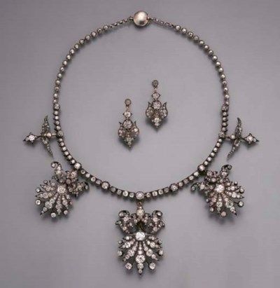 "AN ANTIQUE DIAMOND NECKLACE/TIARA The old-cut diamond collet line suspending three graduated diamond fringe clusters and two smaller pendants to the plain silver beaded backchain, clusters detach, with fittings for brooches, hatpins, and a tiara, with a pair of earrings en suite, mounted in silver and gold, circa 1860, 33.4 cm. long, in original leather cases" © Christie's (quote) via christies.com 1890 Fashion, Antique Diamond Necklace, Vintage Diamond Necklace, Antique Luxury, Diamond Flower Pendant, Dancing Diamond, Diamond Heart Pendant Necklace, Silver Diamond Necklace, Fancy Necklace