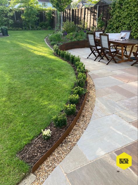 Simple but stunning. Corten sheets with a gradual incline to separate the patio area from the lawn Lawn Separation Ideas, Patio With Gravel Border, Patio Lower Than Lawn, Paving Edging Ideas, Gravel Patio Area, Raised Landscape Border Ideas, Simple Garden Borders, Modern Garden Edging, Border Around Patio