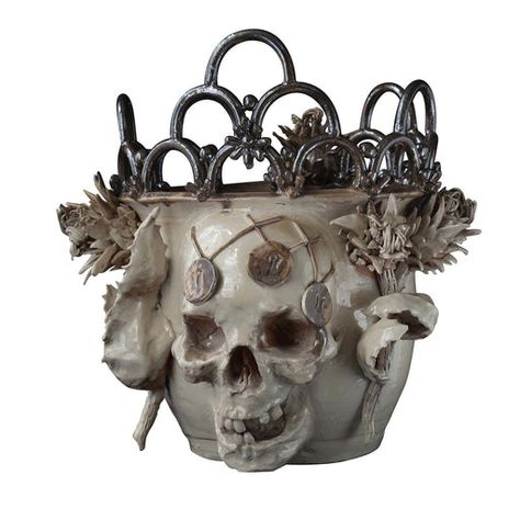 Whether adding a unique gothic accent to a side table or simply celebrating Halloween, this vase hits the nail on the head. Featuring a three-dimensional skull, the glazed ceramic vase is accented with thistles on both sides and topped with metallic rings. The vase is extremely delicate, be cautious when moving and dusting it. Skull Vase, Metallic Rings, Steampunk Mask, Visual Search, Decorative Vases, Vase Crafts, Gothic Decor, Keramik Vase, Ceramic Vessel