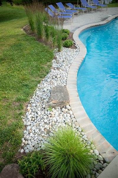 20 Classy Ideas For Landscaping Rock Border Around Pool, Landscaping Around Inground Pool Ideas, Hardscape Around Pool, Pools Backyard Inground Landscaping, Freeform Pool Landscaping, Rock Landscaping Around Pool, Landscaping Around A Pool, Rock Around Pool, Pool Landscaping Ideas Inground