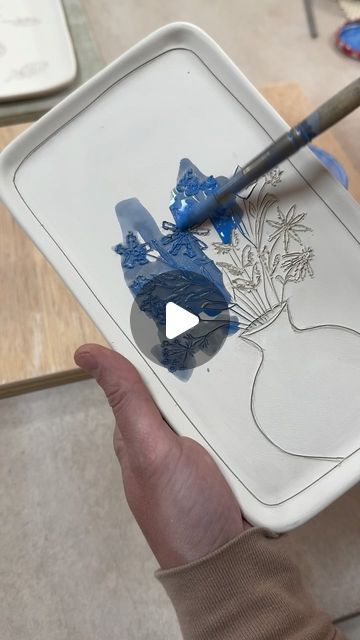 Jenna Vanden Brink Ceramics on Instagram: "Making of this little porcelain tray, from carving the leather-hard piece to pulling it out of the glaze kiln.  Couple things I like:  The carved texture that subtly remains under the clear glaze. It’s a lot of work to individually carve each piece but I think it makes it extra special, so I like that some evidence of the knife cuts remains.  The blue dots on the vase are a nod to my blueberry design 🫐🫐" Cold Finishes For Ceramics, Textured Pottery Ideas, Ceramic Glaze Techniques, How To Glaze Pottery, Glaze Ideas Ceramics, Ceramics Glaze Ideas, Texture On Clay, Pottery Carving Ideas, Underglaze Techniques