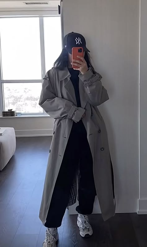 Cozy Trench Coat Outfit, Trench Coat Tracksuit Outfit, Style For University In Iran, Airport Trench Coat Outfit, Trench Coat With Sweatpants, Sweatpants Trench Coat, Styling A Trench Coat Outfit, Grey Raincoat Outfit, Charcoal Trench Coat Outfit