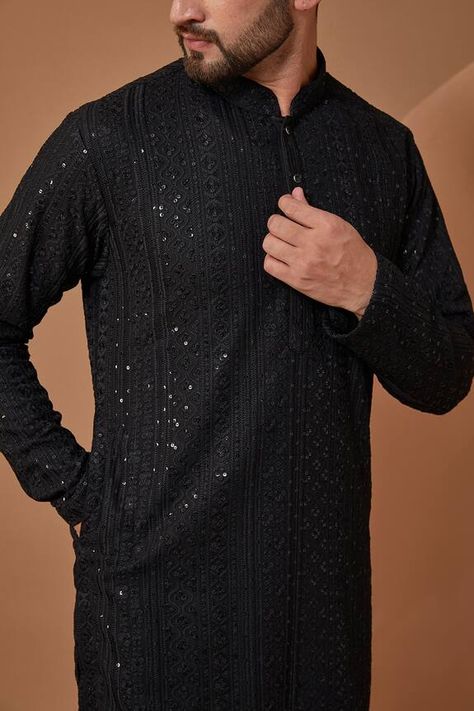 Black georgette kurta with all over chikankari work in sequin embellishments. Components: 1 Pattern: Embroidery Type Of Work: Chikankari Neckline: Stand Collar Sleeve Type: Full Sleeves Fabric: Georgette  Color: Black Other Details:  Note: Pant worn by the model is not for sale Occasion: Sangeet - Aza Fashions Designer Kurti Patterns For Mens, Black Designer Kurta For Men, Pakistani Kurta Designs For Men, Black Kurthi Models Latest, Chicken Kari Kurta For Men, Black Shalwar Kameez For Man, Standing Poses Men, Black Kurta Men, Black Chikankari Kurta