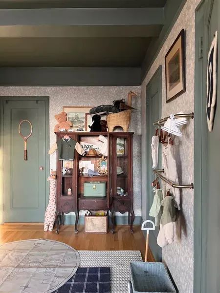 Nursery decor (cabinet is an antique find) #LTKkids #LTKbaby #LTKhome Pretty In The Pines Nursery, China Cabinet In Nursery, Pretty In The Pines Shelby, Feeling Some Type Of Way, Antique Nursery, Pretty In The Pines, Checkered Area Rug, Traditional Nursery, Plaid Rug