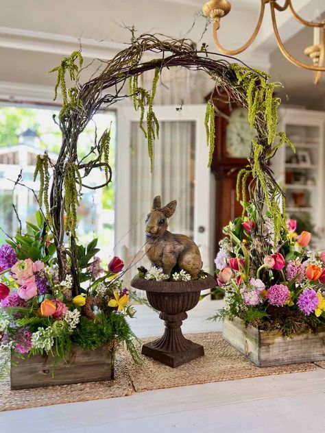 If you're looking for something new and innovative for Easter this year, try a gorgeous fresh spring flower arrangement including an arch. This stunning display is perfect for any Easter celebration and is sure to wow your guests. Learn how to create this look for yourself with all the details in a blog post and youtube video. Willow arch | fresh cut flower arrangement | Easter flower arrangement | Bunny statue with flowers | Bright Spring flowers | Casual garden flower arrangement Large Easter Floral Arrangements, Statue With Flowers, Willow Arch, Table Floral Decorations, Easter Buffet, Easter Outdoor, Easter Floral Arrangement, Basket Centerpieces, Easter Flower Arrangements