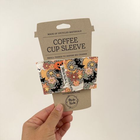 This Halloween reusable coffee cup sleeve is designed to fit standard tapered disposable hot beverage cups to protect your hands from hot beverages. Grab one of these cuties today to keep your hands protected from your hot pumpkin spice latte!Order your preferred beverage from your favorite local coffee shop and tell them you don’t need the single use disposable paper sleeve, you now have your own. Slip your reusable one on your cup and enjoy. Go you!Fabric for these are all remnant pieces from Coffee Cup Sleeve Template, Hot Pumpkin Spice Latte, Reusable Coffee Sleeve, Coffee Cozies, Disposable Coffee Cups, Coffee Cup Sleeves, Cup Sleeves, Reusable Coffee Cup, Coffee Cup Design