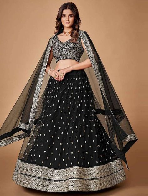 Step into the spotlight with Meghalya's Graceful Black Zari & Sequins Embroidered Net Lehenga. This semi-stitched ensemble features delicate embroidery on sumptuous net fabric, ideal for weddings and partywear. The A-line silhouette of the lehenga, complemented by a matching embroidered net blouse and black dupatta, radiates elegance and charm. Elevate your style and make heads turn with this stunning ensemble. Trendy Lehenga Designs, Flared Lehenga, Black Lehenga, Party Wear Lehenga Choli, Net Blouses, Net Lehenga, Anarkali Gown, Party Wear Lehenga, Designer Lehenga Choli