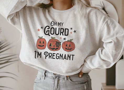 🎃🦇This funny retro "Oh My Gourd" sweatshirt is the perfect way to announce your Fall pregnancy. With Halloween and Thanksgiving just around the corner, this maternity tee is a fun and festive way to share the news with friends and family. Surprise your wife or loved one with this unique baby reveal gift and watch her glow with joy. Celebrate your growing family this fall with this adorable fall pregnancy announcement sweater. So what are you waiting for? Click ADD TO CART now! 👕 PRODUCT INFO Maternity Shirts Thanksgiving, Pregnancy Announcement Thanksgiving, Im Pregnant, Thanksgiving Pregnancy Announcement, Fall Pregnancy, Fall Pregnancy Announcement, Oh My Gourd, Fall Maternity, Pregnancy Announcement Shirt