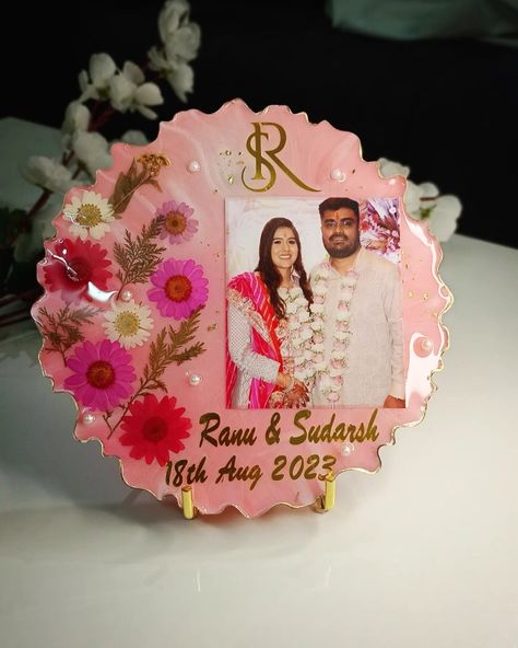 Resin couple photo frame preserving daisy flowers and containing name initials of SR and date of engagement with photo of engagement. Epoxy frame ideas, handmade gift ideas, handmade couple frame from resin, pink white colour frame , Name ranu and sudarsh, frame with fairy light or cork light on the back side and metal stand for holding the frame. Anniversary gift ideas, Birthday gift ideas, Wedding gift ideas, Resin art ideas, Resin things Epoxy Resin Photo Frame, Resin Photo Frame Ideas, Resin Art Frame, Epoxy Frame, Couple Photo Frame, Resin Art Ideas, Frame Anniversary Gift, Cork Light, Couple Frame