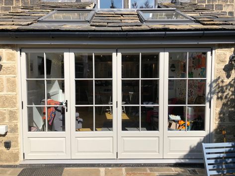 Bifold are often not very suited to period homes.  Simple clean lines tend to lend themselves more to new build and contemporary designed properties.   Try adding raised and fielded panels and glazing bars to match it with the age of your home.  These doors seen here are finished in our French Grey paint. Period House Extension, French Door Bifold, Living Room Bifold Doors, French Doors Extension, French Bifold Doors, Cottage French Doors, French Doors Cottage, Period Bifold Doors, Cottage Bifold Doors