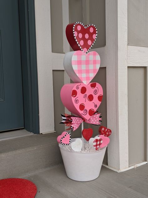 Hand painted and homemade whimsical topiaries. #valentinesday Valentine Door Swag Diy, Outdoor Valentines Decorations, Diy Valentines Decorations Outdoor, Valentines Day Topiary Diy, Outdoor Valentine Decor, Painted Valentine Hearts, Valentines Topiary Diy, Valentine Topiary Diy, Valentine’s Day Centerpiece Diy