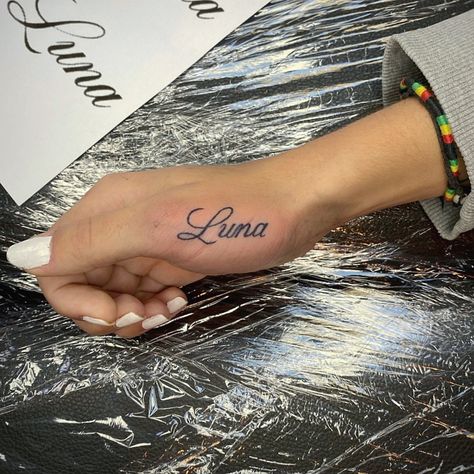 Thumb Word Tattoos, Name On Thumb Tattoo, Name Tattoos Cursive, Names In Cursive Tattoos, Names On Hand Tattoos, Name Tattoos Hand, Hand Name Tattoos For Women, Hand Tattoo Script, Hand Tattoo Name