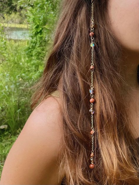 Mars Goddess Hippie Hair Bead: Set with the intention of providing protection and grounding. Perfect for protection during mercury retrograde! Includes a Sensitive Scalp Attachment Clip to attach the Hippie Hair Bead to your hair! Crystals: Glass Shiny Brown Beads and Gold Stone. 🫧Every order comes with a goodie bag full of an assortment of hippie items!🫧 Hippie Hair Beads are made using Sterling Silver Wire/Gold Plated Wire each piece is made with ethnically sourced crystals<3 Each are handma Boho Hair Jewelry, Crystals On Hair, Hippie Hair Jewelry, Cottage Core Hair Accessories, Hair Crystal Accessories, Wire Wrapped Hair Accessories, Hair With Charms, Diy Beaded Hair Accessories, Fairy Hippie Outfits