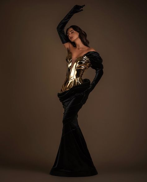 To order DM @reineecouture . Introducing a masterpiece of couture elegance, this stunning gown commands attention with its bold juxtaposition of textures and colors. The bodice, crafted from metallic gold, molds to the body like liquid metal, creating a futuristic and regal effect. This striking top seamlessly transitions into a luxurious black velvet skirt that drapes gracefully to the floor, accentuating the wearer's silhouette with its sculpted lines and dramatic flair. The dress featur... Futuristic Elegance, Futuristic Dress, Black Velvet Skirt, Gold And Black Dress, Liquid Metal, Stunning Gowns, Velvet Skirt, Black Velvet Dress, Fashion Wishlist