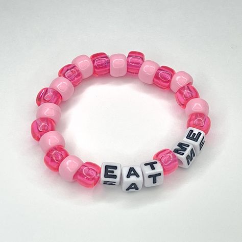 "\"Eat me\" stretchy beaded bracelet Made to order! Please include wrist measurement in centimeters (: Check out our custom listings for more color and word options!" Pony Bead Bracelets Words, Bed Bracelet Ideas, One Word Bracelet Ideas, Sub Bracelet, Pink Bracelets Ideas, Cute Bracelet Making Ideas, Candi Bracelet Idea, Funny Kandi Bracelets Sayings, Silly Bracelet Ideas