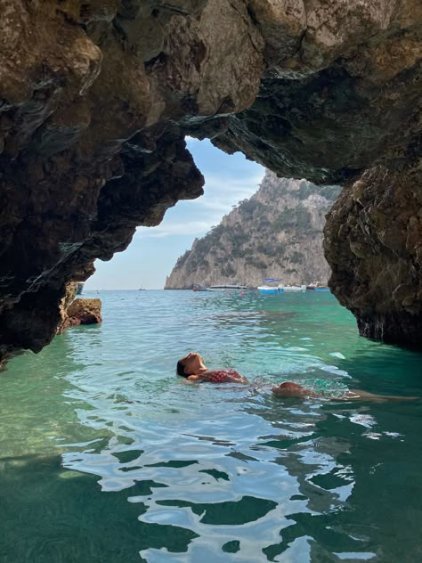 Person swimming in ocean above a cave in Capri, Italy Cave Swimming, Almafi Coast Italy, Ithaca Greece, Italy Vibes, Water Pictures, Italian Vacation, Italy Summer, Capri Italy, Summer Water