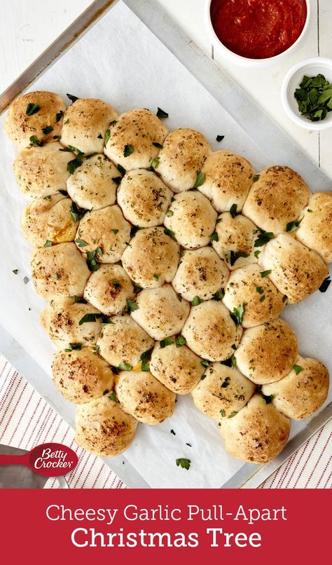 This festive pull-apart, made easy with Pillsbury™ biscuits, is loaded with Cheddar, mozzarella and Colby-Monterey Jack cheeses for a surprise in every warm, garlicky bite. Biscuit Mozzarella Christmas Tree, Cheesy Garlic Pull Apart Christmas Tree, Garlic Rolls Christmas Tree, Mozzarella Christmas Tree Bites, Cheesy Garlic Pull Apart Bread Christmas Tree, Garlic Cheese Pull Apart Bread With Biscuits, Christmas Tree Cheese Bites, Pull Apart Biscuit Bread, Pillsbury Pull Apart Christmas Tree