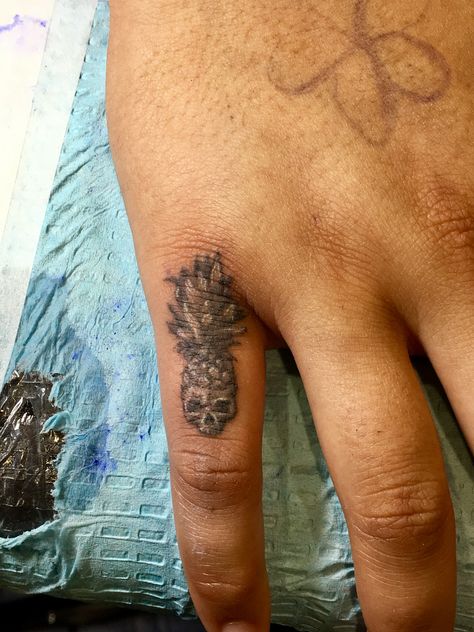 Pineapple skull finger tattoo Skull On Finger Tattoo, Pineapple Finger Tattoo, Skull Finger Tattoo, Dainty Pineapple Tattoo, Pineapple Skull Tattoo, Unique Pineapple Tattoo, Black And White Pineapple Tattoo, Skull Finger Tattoos, Wrist Hand Tattoo