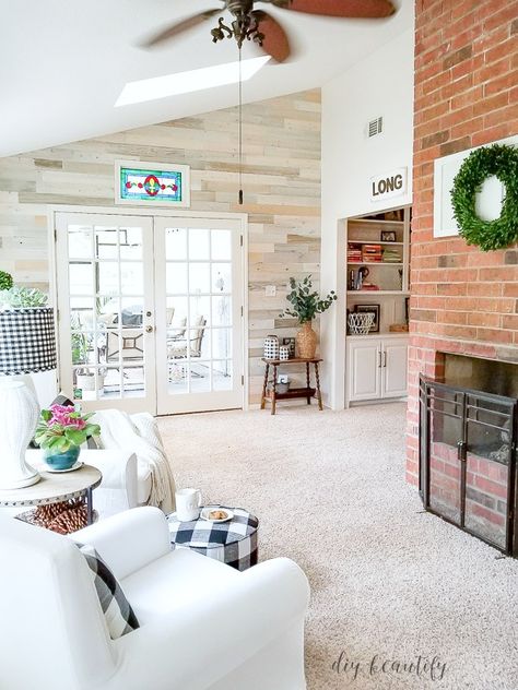 A gorgeous sunroom makeover! The clutter is gone, there are new coastal white wood walls and timeless decor! Come by diy beautify for a closer look. Ottoman Diy, Sunroom Makeover, Brick Accent Walls, Grey Accent Wall, Diy Ottoman, White Wood Wall, Coastal White, Wood Accent Wall, Coastal Living Rooms