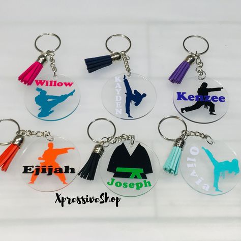 "A handmade personalized karate/martial arts keychain just for you.  To order, please see design photo on listing. Design color is for each silhouette and belt color. Enter the name & name color in the personalization box. If no specification is given for the name color, I will use either black or white depending on the design color chosen. Each keychain comes with a silver ring and leather tassel; sizes include 2\" or 2.5\". Feel free to visit my site for more options - www.AmorAmra.com" Gifts For Track Athletes, Cross Country Coach Gifts, Track And Field Senior Gifts, Senior Track Gifts, Cross Country Gift Ideas, Basketball Bag Tags, Track Tips, Circut Joy, Volleyball Bag Tags