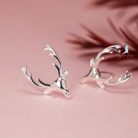 Unleash your inner wild with our Deer Antler Sterling Silver Stud Earrings! Crafted with genuine sterling silver and featuring intricately detailed antler designs, these earrings are perfect for nature lovers and adventurous fashionistas alike. Stand out in style and show your love for the great outdoors with these unique and stunning earrings. Materials: 925 sterling silverDimensions: 0.60 x 0.39 Jewelry Care: See more information about how to care for your jewelry here. Shipping Policy: Orders will be shipped within 1-3 business days. Economy shipping will take 7-14 days to arrive and standard shipping is 1- 4 days for U.S. orders. International shipping time is depended on the country and per shipping method. Shipping cost will be calculated at check out.For more details, see our Shippi Antler Design, Silver Jewelry Earrings, Handmade Fashion Jewelry, Animal Earrings, Sterling Silver Stud Earrings, Deer Antler, Deer Head, Holiday Jewelry, Silver Stud Earrings