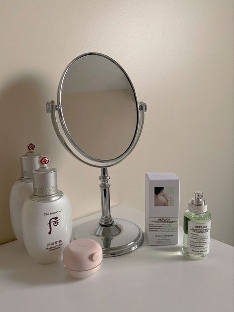 a clean minimalistic desk displaying vanity mirror surrounded by luxurious skincare and perfume products Desk Mirror Aesthetic, Cottagecore Apartment Decor, Cottagecore Apartment, Minimalistic Desk, Room Decor Desk, Perfume Vanity, Korean Apartment, Replica Perfume, Tabletop Vanity Mirror