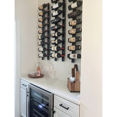 Scale a column of Bronc Vino Pins straight up the wall to maximize space or tilt them up to 45 degrees for a designer’s edge-to-wine storage with the Bronc Vino Pins Flex system. Flex offers a dynamic mounting option to Latitude Run®’s patented wine peg system with the addition of a simple vertical mounting system that mixes up the aesthetic and simplifies installation. This complete system includes everything you need to install one column of label-forward Vino Pins and a choice of bottle depth Modern Wall Wine Rack, Built In Wine Bar, Wine Wall Display, Wall Hanging Wine Rack, Small Wine Racks, Wine Room Design, Black And White Dining Room, Wine Bottle Wall, Wine Closet