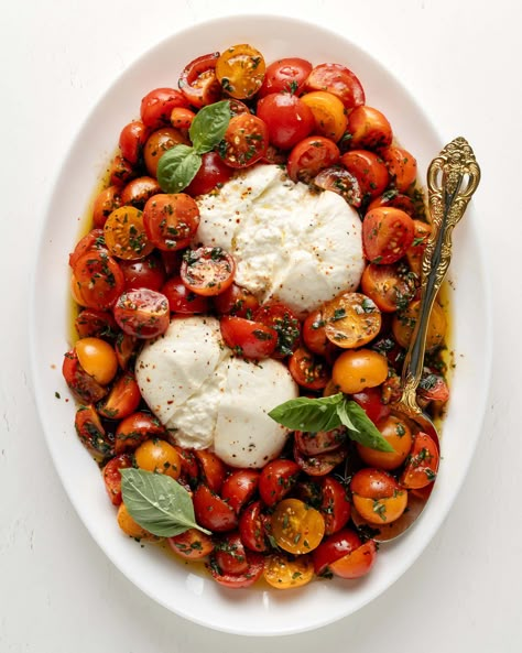 Burrata Caprese is a twist on the classic Caprese salad. Marinated cherry tomatoes on top of creamy burrata drizzled with olive oil and flakes of sea salt. This recipe is fresh flavorful and perfect for summer! Caprese Salad Burrata, Marinated Burrata, Summer Burrata, Marinated Cherry Tomatoes, Burrata Caprese Salad, Tomato Burrata Salad, Burrata Caprese, Caprese Recipes, Caprese Salad Recipe