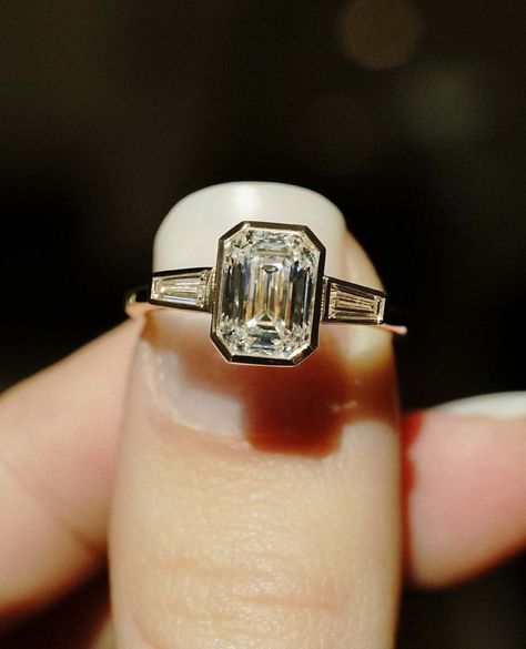 Bezel Set 1.85 Ct Emerald Cut Moissanite Engagement Ring, Emerald Cut Ring, Moissanite Engagement Ring, Three Stone Emerald Cut Ring ✥ 𝐌𝐚𝐢𝐧 𝐒𝐭𝐨𝐧𝐞 𝐃𝐞𝐭𝐚𝐢𝐥𝐬 ↣ Shape: Emerald Cut ↣ Type: Moissanite ↣ Weight: 1.85 Ct Emerald (App.) (8.25 X 5.87 X 3.92 mm) ↣ Color: Colorless ↣ Clarity: VVS ↣ Making Process: Handmade - Crafted by our experienced team ✥ 𝐑𝐢𝐧𝐠 𝐃𝐞𝐭𝐚𝐢𝐥𝐬 ↣ Band Width: 1.8 mm (± 0.10) [Customization Possible] ↣ Metal Purity: Solid Gold (10KT, 14KT, 18KT); Silver (92 Weddin Rings, Three Stone Emerald Cut Ring, Three Stone Engagement Rings Emerald, Moissanite Engagement Ring Emerald Cut, Moissanite Engagement Ring Emerald, Engagement Ring Three Stone, Engagement Ring Emerald Cut, Emerald Cut Moissanite Engagement Ring, Emerald Cut Ring