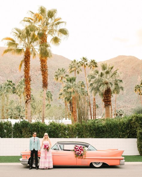 Couple with pink classic car. Modern vintage-inspired Palm Springs engagement session with a 1960s Cadillac, retro clothing, and flowers by Shindig Chic. | Colorful and elevated wedding inspiration for fun-loving couples in Southern California | #engagementsession #PalmSpringsengagement #vintageweddingdress #floralcar #pinkcar   Source: Mary Costa Photography | Los Angeles Spring Engagement Photos, Palm Spring, Palm Springs Wedding, Spring Engagement, Los Angeles Wedding Photographer, Retro Wedding, Wedding Los Angeles, Elope Wedding, Engagement Shoots