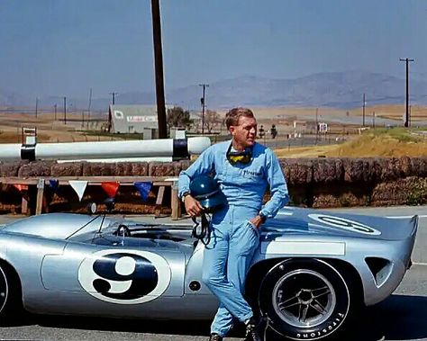 Steve McQueen, in a Firestone racing suit, leans against a Lola T70 SL70/14 Can-Am car at Riverside Raceway, Riverside, California, July 1966. The hot setup for Can-Am racing was a T70 Chevrolet V8, and the Lola cars took a big endurance win with a one–two finish in the 1969 24 Hours of Daytona. McQueen was a serious sports car racer, taking two SCCA Nationals and a 2nd place finish at the 12 hrs of Sebring in a Porsche 908. #SteveMcQueen #LolaT70 #SCCA Riverside Raceway, Actor Steve Mcqueen, Steve Mcqueen Style, Steven Mcqueen, Steve Mc, Mc Queen, Car Racer, Classic Racing Cars, Jaguar Xk