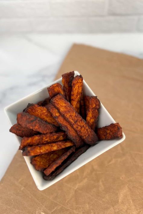 This tasty, sweet, and smoky tempeh bacon recipe is made in the air fryer. The air fryer gives it a wonderful crispiness on the outside. This vegan bacon recipe is delicious in breakfast tacos, a wrap, crumbled on top of a salad, and as a side dish with banana oatmeal waffles. It's gluten-free, oil-free, high in protein, has no added sugar, and is ready in 20 minutes! Banana Oatmeal Waffles, Tempeh Bacon Recipe, Vegan Bacon Recipe, Daniel Fast Meal Plan, Tempeh Stir Fry, Oatmeal Waffles, Tempeh Bacon, Daniel Fast Recipes, Tempeh Recipes