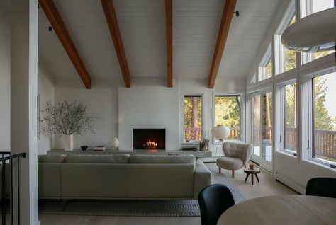 Photo 8 of 18 in Before & After: A Wood-Laden Lake Tahoe Cabin Gets a Dose of Scandi Cool - Dwell Noguchi Lamp, Lake Tahoe Cabin, Armadillo Rug, Tahoe Cabin, Cabin Renovation, Fireplace Facade, Nordic Furniture, Exclusive Home, Entrance Mat