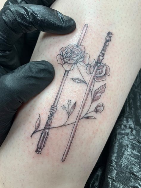 Leia and Rey’s lightsabers tattoo Starwars Harry Potter Tattoo, Rey Lightsaber Tattoo, Rey Star Wars Tattoo, Star Wars Rey Tattoo, Star Wars Tattoo With Flowers, Wand And Lightsaber Tattoo, Star Wars Tattoo Feminine, Rey Tattoo Star Wars, Princess Leia Lightsaber Tattoo