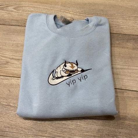 *Please Allow Up To A Week For Your Order To Be Shipped Due To Increased Demand And Because These Items Are Handmade* This Is A Made-To-Order “Appa” Design Embroidered On A Light Blue Gildan Heavy Blend Crewneck Sweatshirt. The Photos Are Of One I Made Myself So It Will Look Exactly Like That! Available In Sizes S-Xxl! The Sizing Is Unisex And Fits True To Size. I Also Do Custom Embroidery Orders Feel Free To Message Me Here For More Information! Thank You For Checking Out My Listing, And Let Me Georgia Bulldogs Hoodie, Lacrosse Hoodie, Light Blue Crewneck, Michigan Sweatshirt, Vintage Nasa, Shirts Nike, Brown Hoodie, Blue Crewneck, Yellow Hoodie