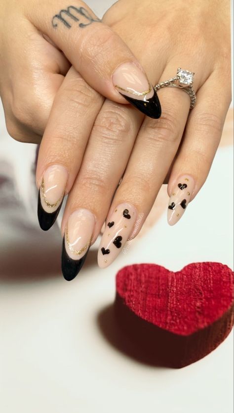 A black and gold double french.. little black hearts are the perfect way to ccmplete this chic look for Valentine’s Day. #valentinesday #valentinesdaynails #blackvalentinesnails #blackhearts #blackandgold #almondshapednails #almondnails #frenchnails #goldglitter #cnd #cndshellac #cndnaea #cndworld #coutureyourmani #bestoflongisland #lovewins #loveisintheair Black And Gold Heart Nails, Black Heart Nail Art, Black Nail Heart Design, Black Nails With Gold Heart, Black Nails With Hearts Art Designs, White Nails With Black Heart Art Designs, Couture Nails, Cnd Nails, Heart Nail Art