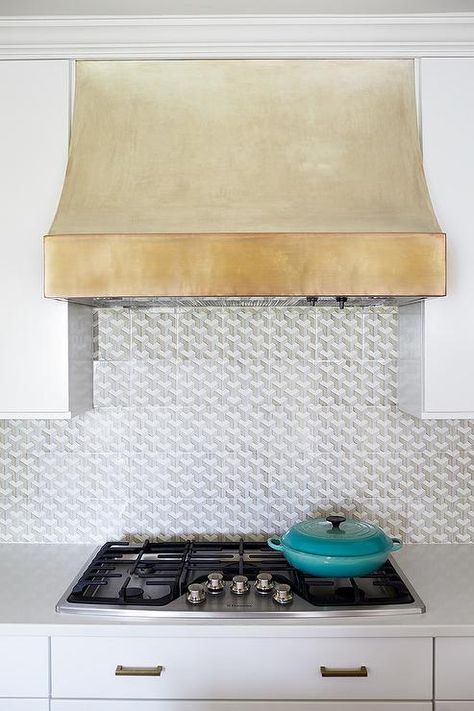 A gold kitchen vent hood is an eye catching feature over a stainless steel stove amongst white quartz countertops. Oven Hood, Kitchen Vent Hood, Hood Ideas, Kitchen Vent, Farmhouse Backsplash, Beadboard Backsplash, House Of Turquoise, Vent Hood, Kitchen Hoods