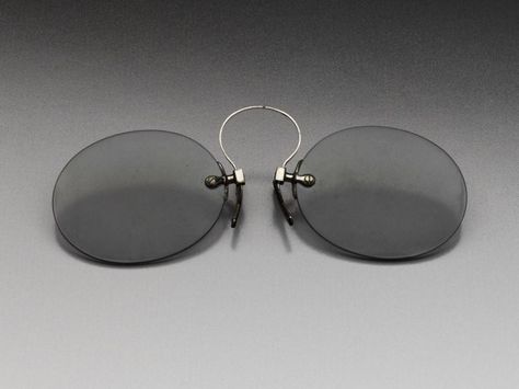 Pince nez, glass, metal and leather, early 20th century, American. Edwardian Men, Curved Bridge, 1900's Fashion, 1900s Fashion, Fallen London, Bram Stoker, Eyewear Design, Head And Neck, Eye Glasses