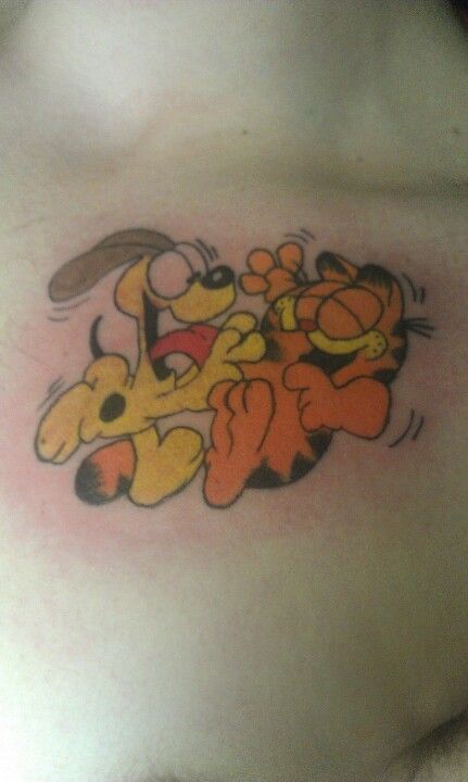 Garfield and Odie Garfield And Odie Tattoo, Odie Tattoo, Garfield Tattoo, Garfield Stuff, Tattoos 2024, Garfield Images, Favorite Tattoos, Cartoon Tattoo, Garfield And Odie