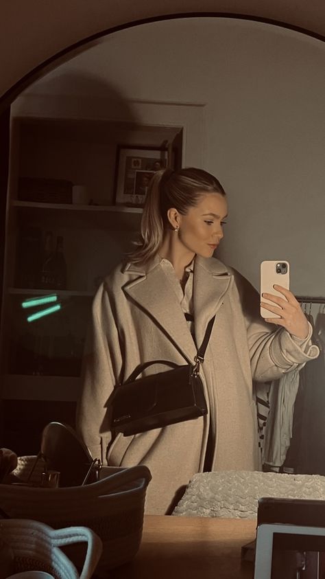 Oversized beige coat styled with a slicked back pony tail and Le Grand Bambino, Jacquemus. Large Jacquemus Bag, Jacquemus Large Bag, Jacquemus Bag Outfit, Bambino Jacquemus, Jaquemus Bag Le Grand Bambino, Jacquemus Le Bambinou Bag, Jacquemus Bambino, Jacquemus Le Grand Bambino, Jacquemus Le Bambino Bag