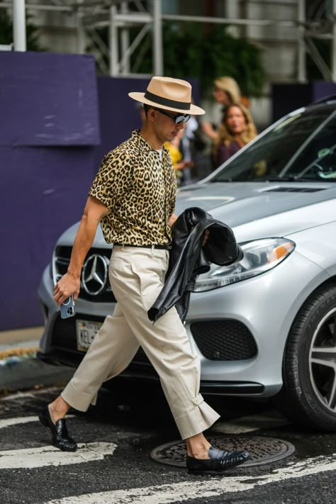 A stylish fedora, button-down cheetah print shirt, some khaki trousers and classic loafer makes this mens street style look come to life. Mens Cheetah Print Outfit, Leopard Shirt Outfit Men, Leopard Shirt Outfit, Nyfw 2022, Printed Shirt Outfit, Mood Board Fashion Inspiration, Cheetah Print Outfits, Cheetah Print Shirt, Cheetah Print Shirts