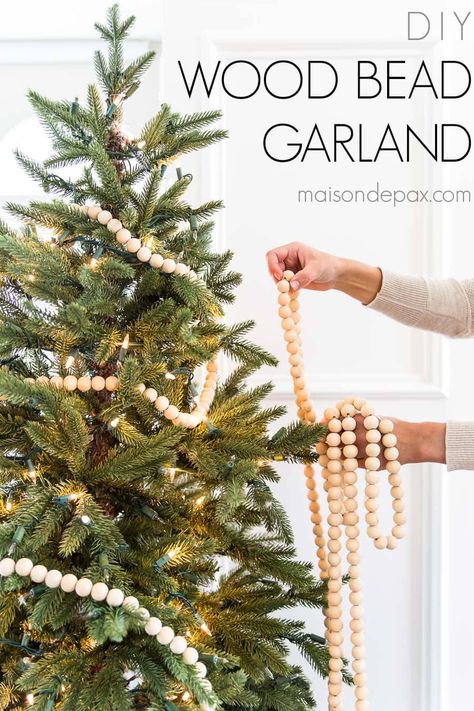 Get the tutorial for DIY wood bead garland. This Christmas home decor craft is easy, affordable, and beautiful! Diy Wood Bead Garland, Diy Christmas Tree Garland, Bead Garland Christmas Tree, Christmas Bead Garland, Christmas Tree Beads, Diy Christmas Garland, Wooden Bead Garland, Black Christmas Trees, Christmas Tree Garland