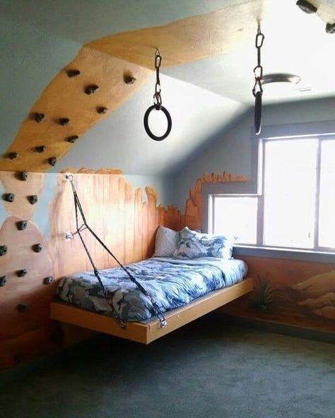 Great rock climbing themed room. The platform bed is suspended with rope and carabineers. The walls are painted with a beautiful Southern Utah scene. And just for fun, gymnastics rings hang from the ceiling.⠀ #woodworkingprojects #woodworkersofig #woodworkerlife #woodworkingplans #woodworkings #woodwork_design #woodworkcraft #handtoolwoodworking #finewoodworking #woodworking_art #woodworkforall #woodworkz #woodworks #woodshoplife #palletwood #handtoolsonly #salvagedwood Suspended Bed, Home Climbing Wall, Gymnastics Room, Platform Bed Designs, Wall Climbing, Diy Platform Bed, High Beds, School Room, Themed Room