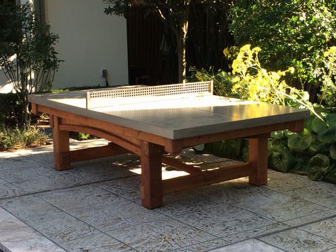 This one of a kind outdoor ping pong table was a custom request from the Otness Family. They really wanted a cohesive look to match the custom playhouse we made in the Spring. I used spare parts from their playset build and created this fantastic redwood base for a concrete ping pong table top. Concrete Ping Pong Table, Ping Pong Table Top, Custom Treehouse, Outdoor Ping Pong, Outdoor Table Tennis, Outdoor Table Tennis Table, Outdoor Ping Pong Table, Custom Playhouse, Outdoor Pool Table