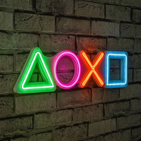 Add a pop of color to your gaming setup with a PlayStation Neon Sign. This eye-catching accessory is the perfect addition to any gamer’s room, providing a cool and retro vibe. The neon lights create a unique ambiance that sets... PlayStation Neon Sign on Cool Stuff To Buy inc - Find Cool Things To Buy! (Gifts 2023) Neon Game Room Ideas, Gamer Room Accessories, Gamer Neon Sign, Gaming Room Accessories, Playstation Room, Podcast Room, Biggest House, Sala Cinema, Gaming Display